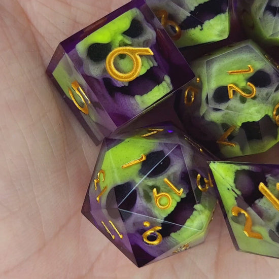 Close-up of purple resin dice with acid-green undead zombie skulls and gold numbers, handcrafted by Mefisto_Dice