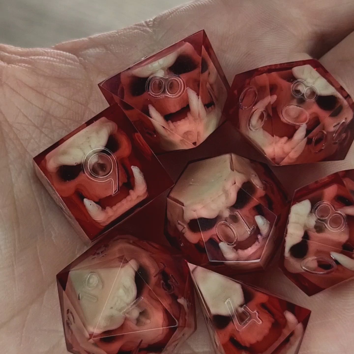 Red resin DnD dice set with detailed orc skulls inside