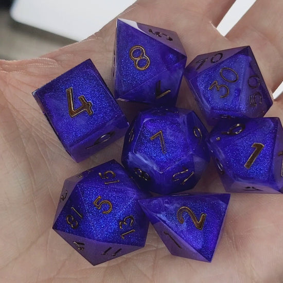 Deep blue and purple shimmering resin DnD dice set with gold numbers