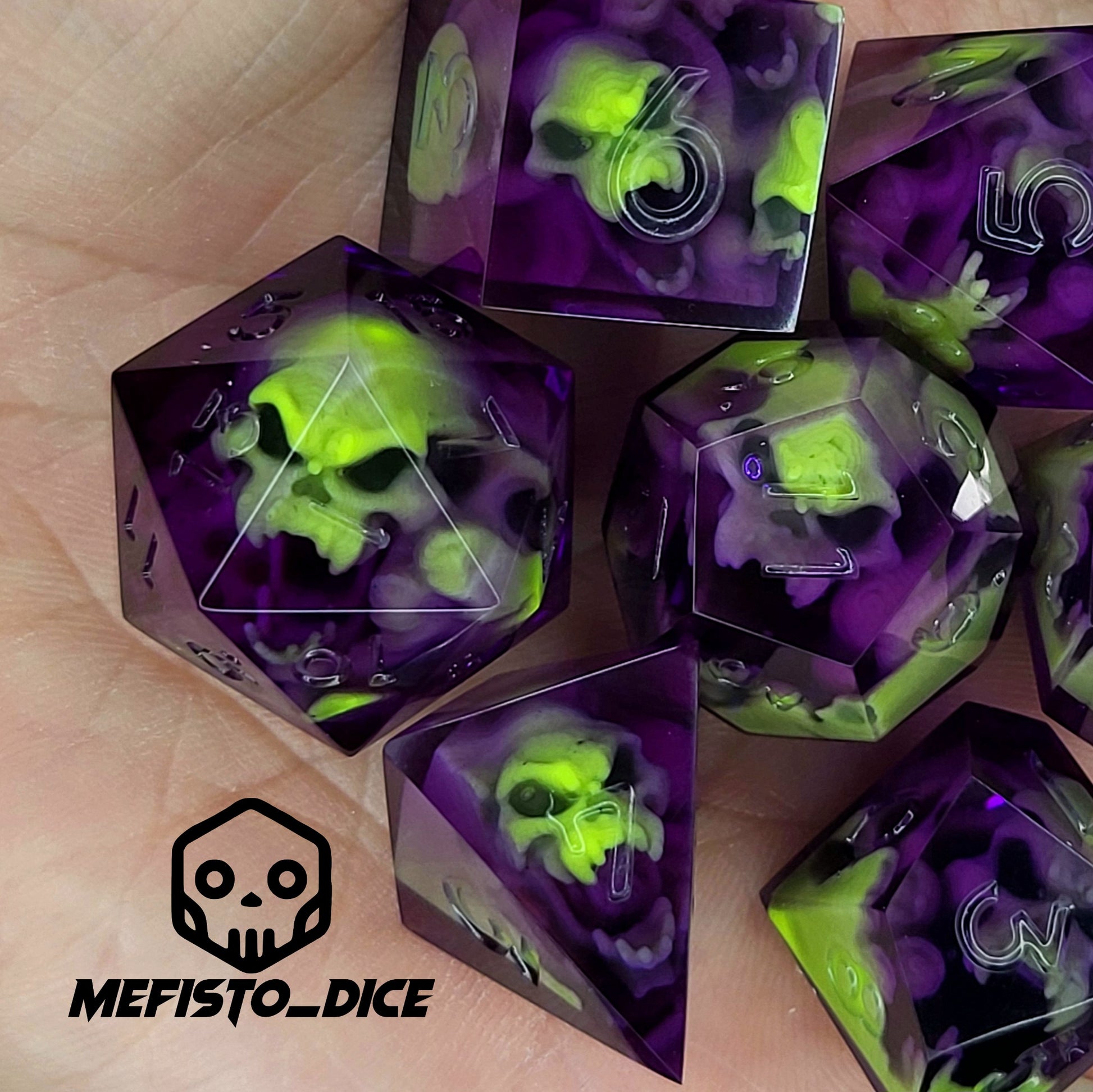 Purple resin DnD dice set with neon green skulls inside