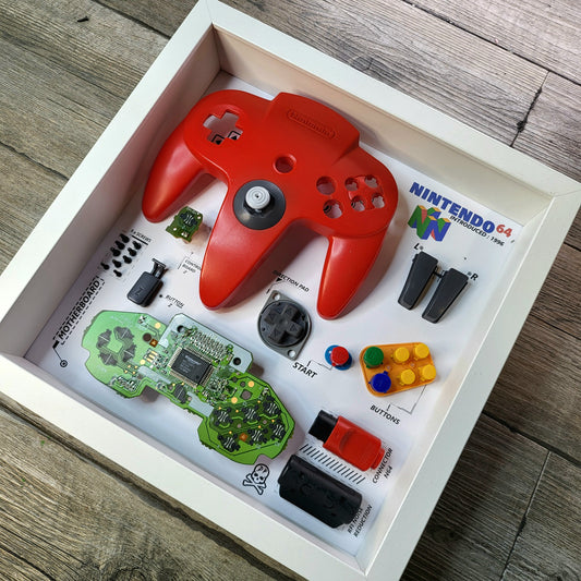Shadow Box 10x10 with wood frame and polycarbonate glass for wall and Tabletop containing a disassembled controller for Playstation and Nintendo